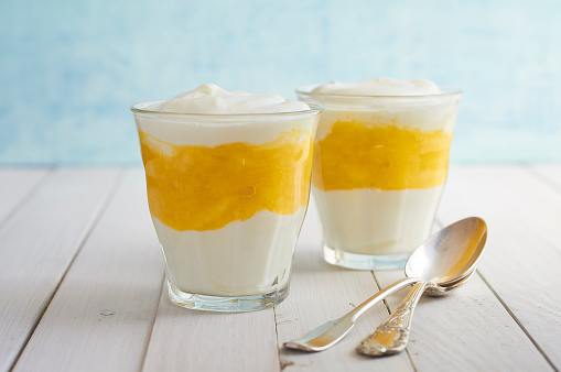 Vanilla Mango Dessert in bistro glasses with two spoons