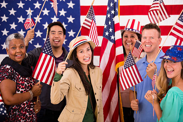 istock Multi-ethnic group. American people at political rally. USA flags. Voting. 485423202