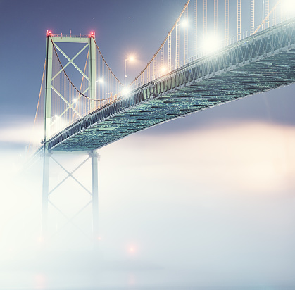 The A. Murray MacKay Bridge dissapears into a thick fog bank on the Dartmouth side of Halifax Harbour.  Long exposure.