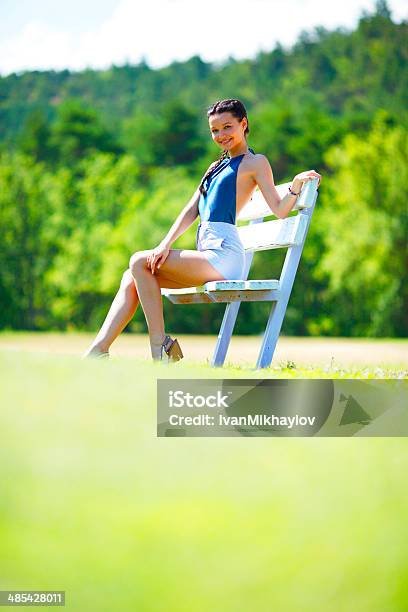 Young Woman Sitting On The Bench In Park Stock Photo - Download Image Now - Adult, Adults Only, Beautiful People