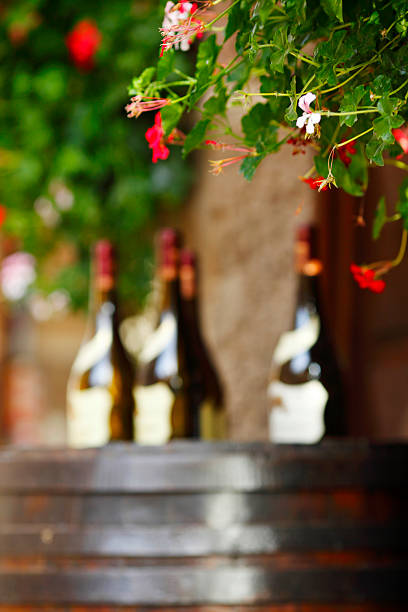 Wine bottles on wodden barrel, winemaking concept