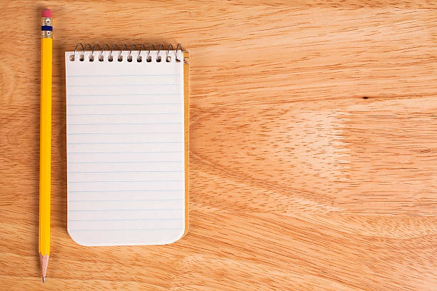 istock White notepad, pencil on wooden office desk. 485428338