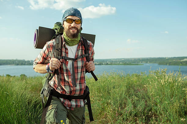 istock Young caucasian man with backpack walking on the top of 485428510