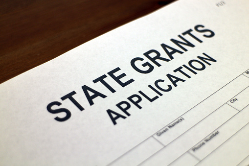 Someone filling out State Grants Application Form
