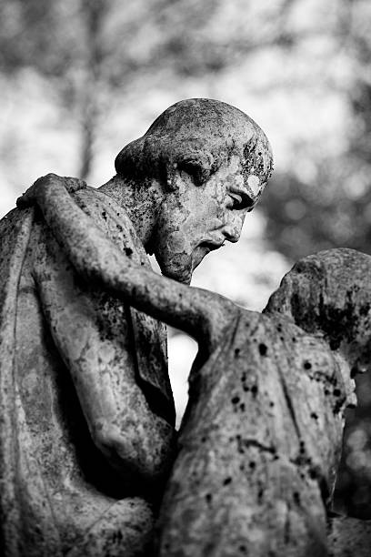 istock Old and weathered statue on an abandoned grave 485430240