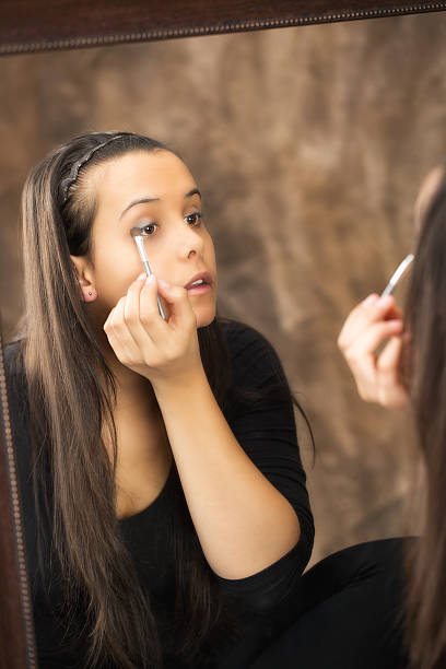 istock Young caucasian woman applying eye-shadow 485434918
