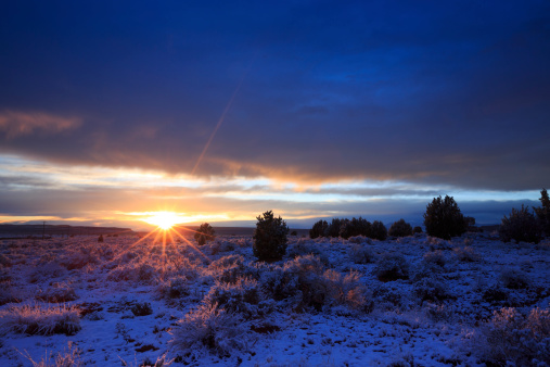 The sun sets after a rare desert snow storm blankets the sagebrush of the Arizona Strip near the Utah/Arizona border.