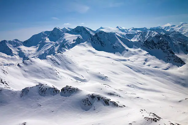 Winter snow covered mountain peaks in Austrian alps. Great place for winter sports