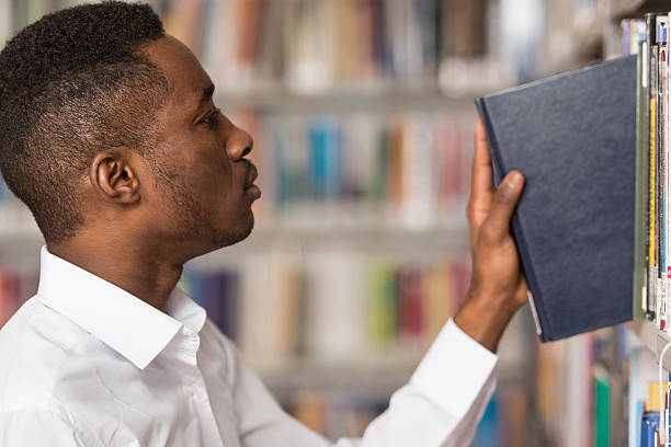 istock Male College Student In A Library 485441106