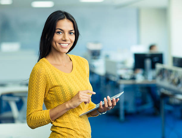istock Businesswoman standing with tablet computer in office 485444784