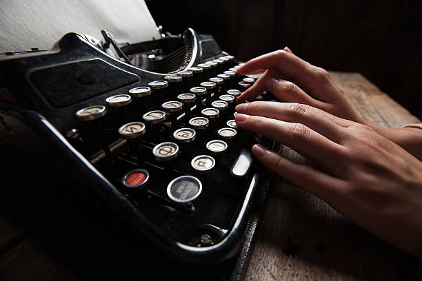 istock Hands writing on old typewriter over wooden background 485444888