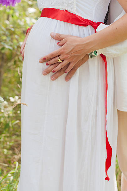 istock pregnant woman touching her belly with hands 485445404