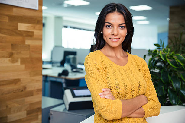 istock Businesswoman standing with arms folded in office 485445582