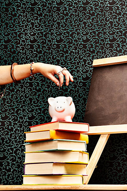 istock How to save! Classroom demonstration using piggybank. 485446215