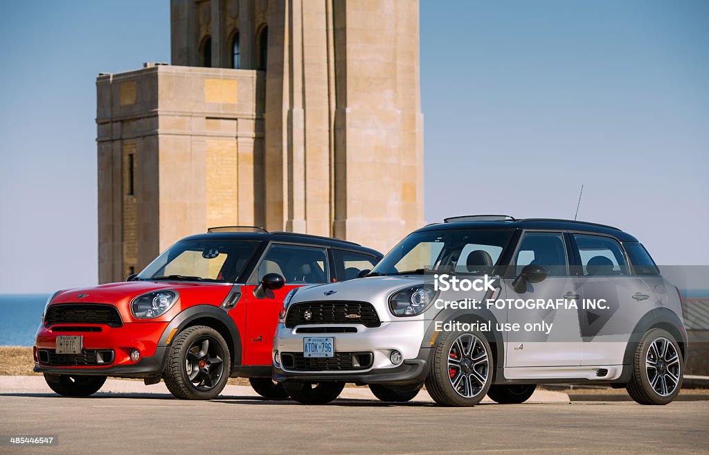 Mini Cooper SUVs in spring time Toronto, Ontario, Canada- April 6, 2014. Pair of Mini Cooper S small SUV vehicles parked against great architecture at The Beach area of Toronto, near Lake Ontario. One MINI is Countryman S ALL4 JCW version, 4 doors with upgraded engine and suspension and the other is Paceman S ALL4 with 2 doors on the same platform as the other only in coupe body styling. Mini has been around since 1959 and has been owned and issued by various car manufacturers. It is currently distributed as a BMW brand of vehicles. Alloy Wheel Stock Photo