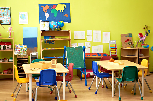 Colorful preschool tables with chairs and things for education