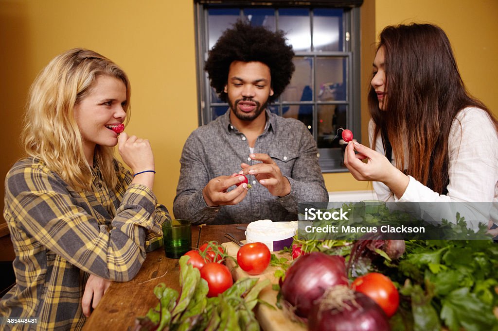 Enjoying the garden harvest Friends eating their freshly grown produce 20-29 Years Stock Photo