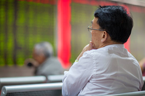 Chinese Citizens Watching Stock Market, Beijing 2015 Beijing, China - August 24, 2015: Chinese Citizens Watching Stock Market at China Securities ticker tape machine stock pictures, royalty-free photos & images