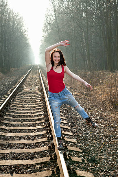 istock Young girl balancing on rails. 485450193