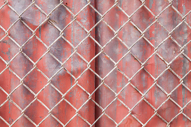 istock Wire Mesh and red corrugated fence 485451037