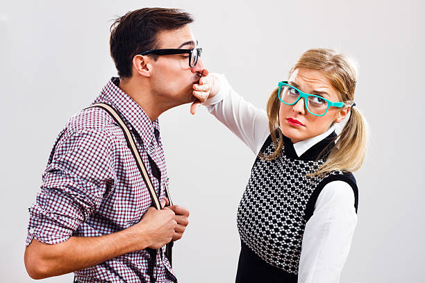 Get away from me! Nerdy man is trying to kiss his nerdy lady ,but she is pushing him away. blind date stock pictures, royalty-free photos & images