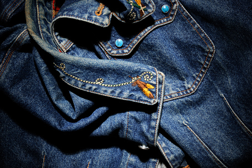 Close-up of old denim jacket with spotlight.