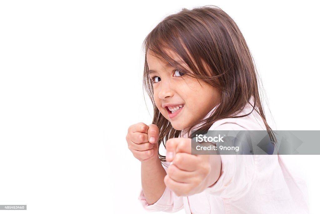 little girl assuming stance, practicing martial arts, self-defen little girl assuming stance, practicing martial arts, self-defense, kungfu, karate, boxing Child Stock Photo