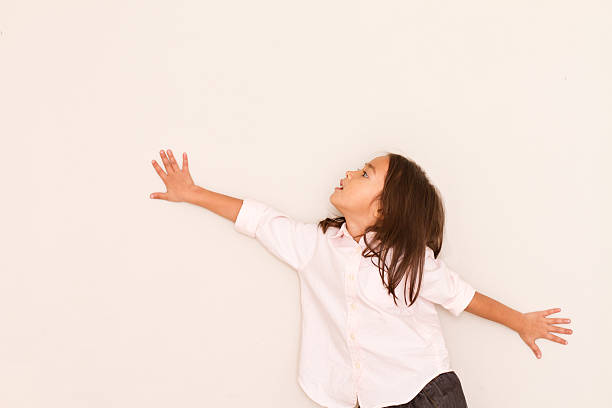 istock happy little girl looking up 485453484