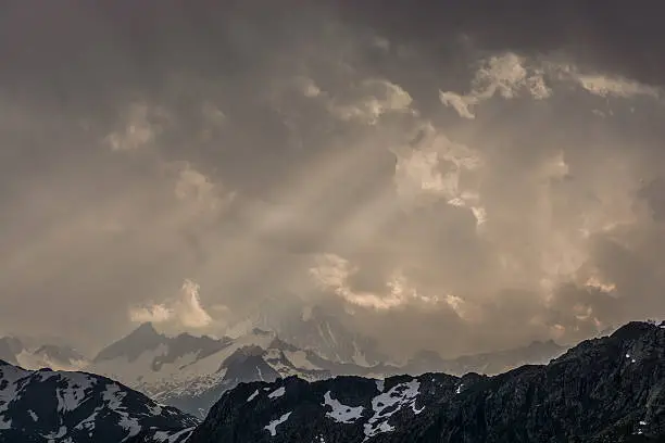 Finsteraarhorn peak Berner Oberland sunbeams and storm coming