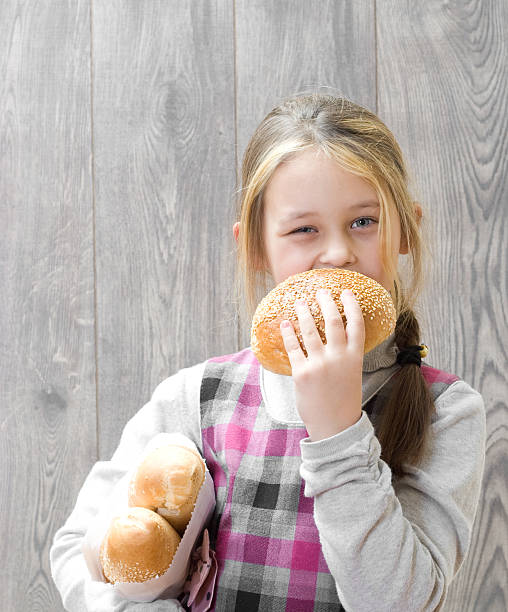 istock girl  bites a piece of bread 485454130