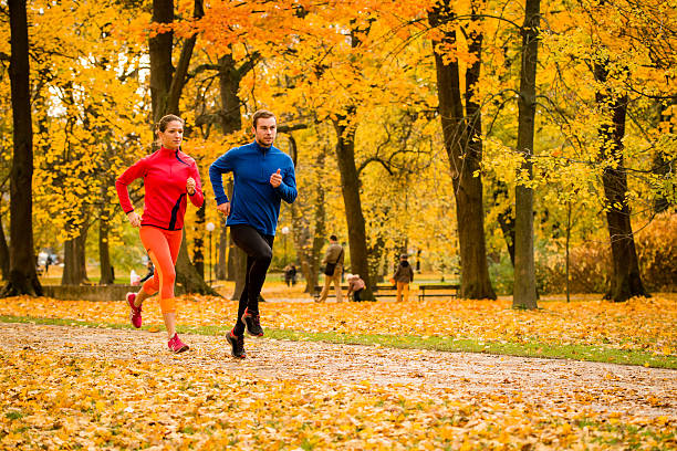 istock Couple jogging in autumn nature 485457594