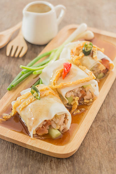 istock Spring rolls with vegetables and chicken on wooden plate 485461458