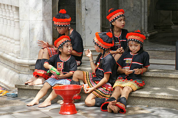 Hill tribe kids relax from dance show Chiangmai, Thailand - 28 June 2015 : Unidentified hill tribe kids relax from dance show for donation at Doi Suthep Temple, Chiangmai, north of Thailand. padaung tribe stock pictures, royalty-free photos & images
