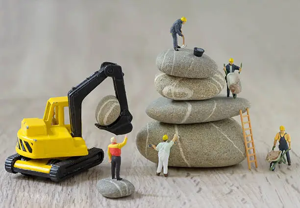 Photo of Pebbles stack and figurines workers