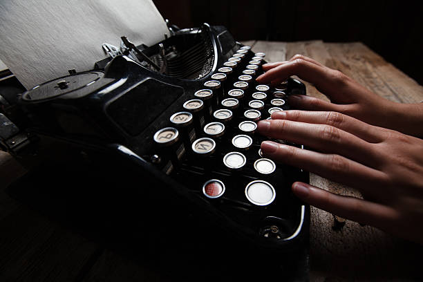 istock Hands writing on old typewriter over wooden background 485464920