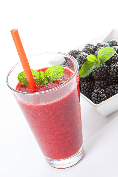 Blackberry smoothie with fruit and mint leaf stock photo