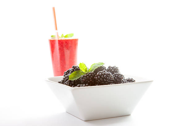 Blackberry smoothie with fruit and mint leaf stock photo