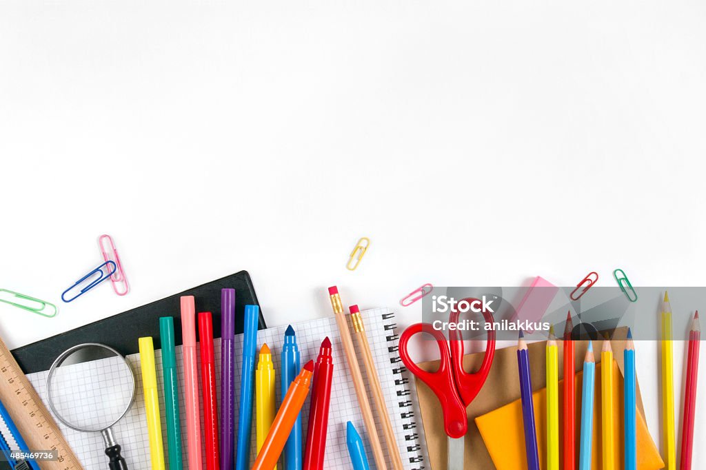 School Equipments and Accessories "Back to School" concept with school supplies on white background. They are on the bottom border of it, middle of the chalkboard is empty, so you may write, or add something on it. School Supplies Stock Photo