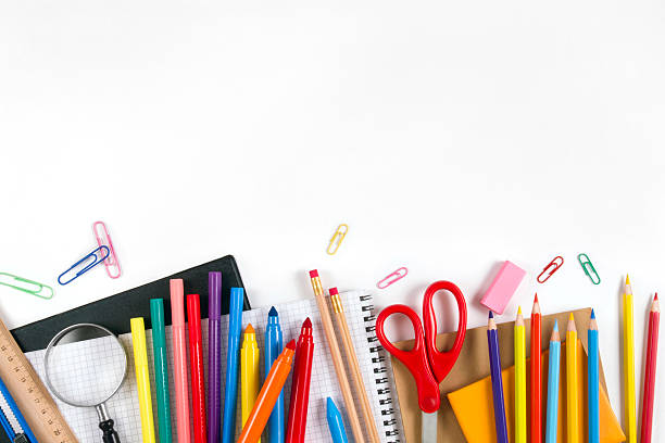 School Equipments and Accessories "Back to School" concept with school supplies on white background. They are on the bottom border of it, middle of the chalkboard is empty, so you may write, or add something on it. school supplies stock pictures, royalty-free photos & images