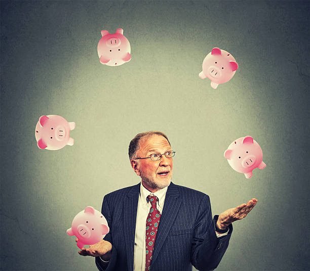 Mature happy business man juggling money Mature happy business man juggling money ponzi scheme stock pictures, royalty-free photos & images