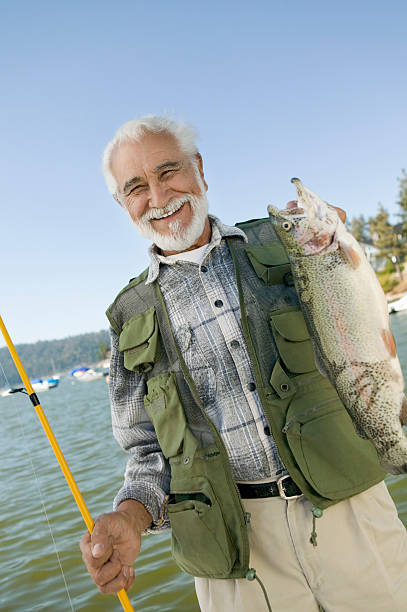 istock Middle-Aged Man Holding Up Trout 485470637