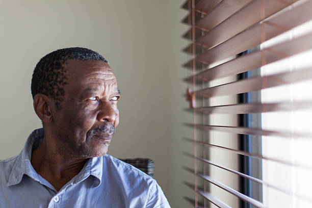 istock African senior looking out of the window with curiosity 485470901