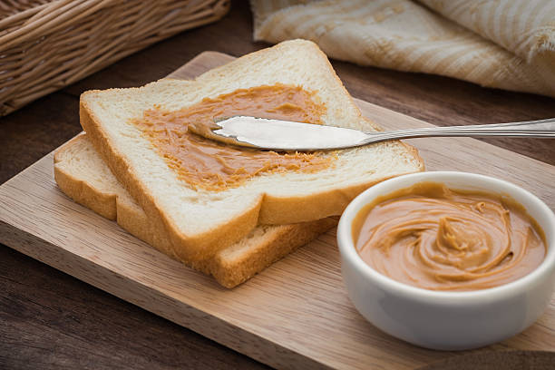 istock Peanut butter sandwich on wooden board 485471384