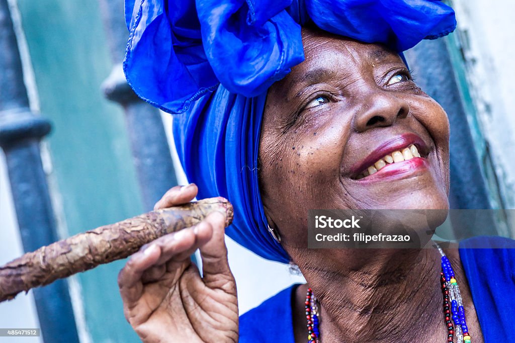 Portrait of african cuban woman smoking cigar in Havana, Cuba Cuba Stock Photo