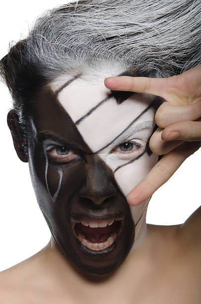 istock Screaming woman with face art and rock gesture 485471815