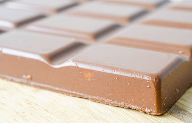istock Chocolate bar on wooden table 485471886