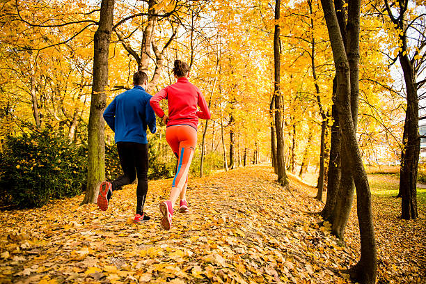 Couple jogging in autumn nature stock photo