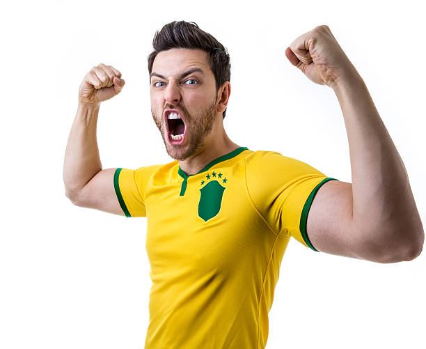 istock Brazilian soccer player celebrates on white background 485472500