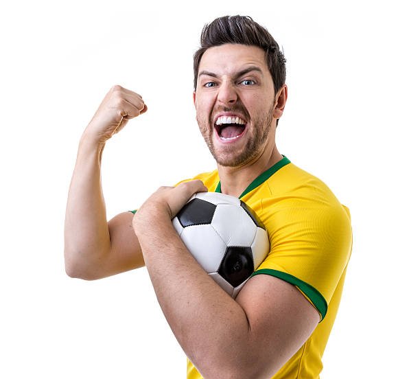 istock Brazilian soccer player celebrates on white background 485472644