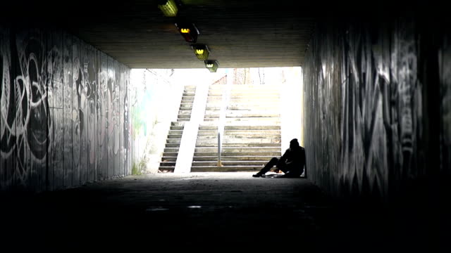 HD DOLLY: Homeless Person Eating In An Underpass